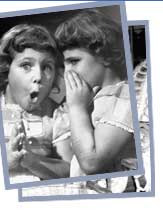 Two girls telling secrets.